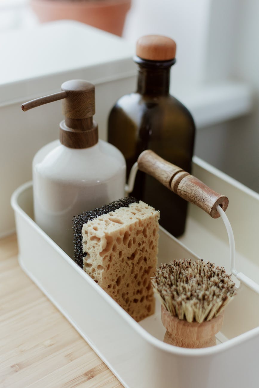 close up view of soap sponge brush and glass bottle